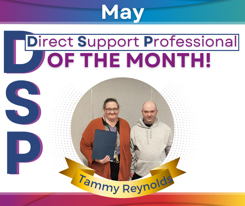 Pictured: One lady and one man standing together smiling in the DSP of the month picture frame.