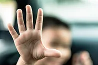 Child holding hand up to camera