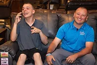 Two men smiling